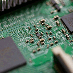 Close-up view of a green circuit board featuring electronic components and microchips